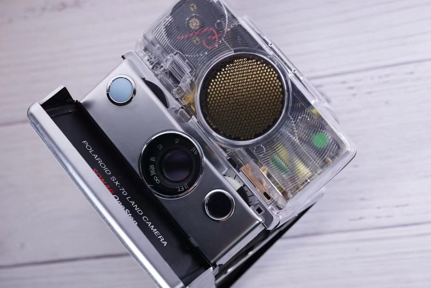 Polaroid SX70 SONAR Transparent vision ISO600 BABY BLUE Shutter button