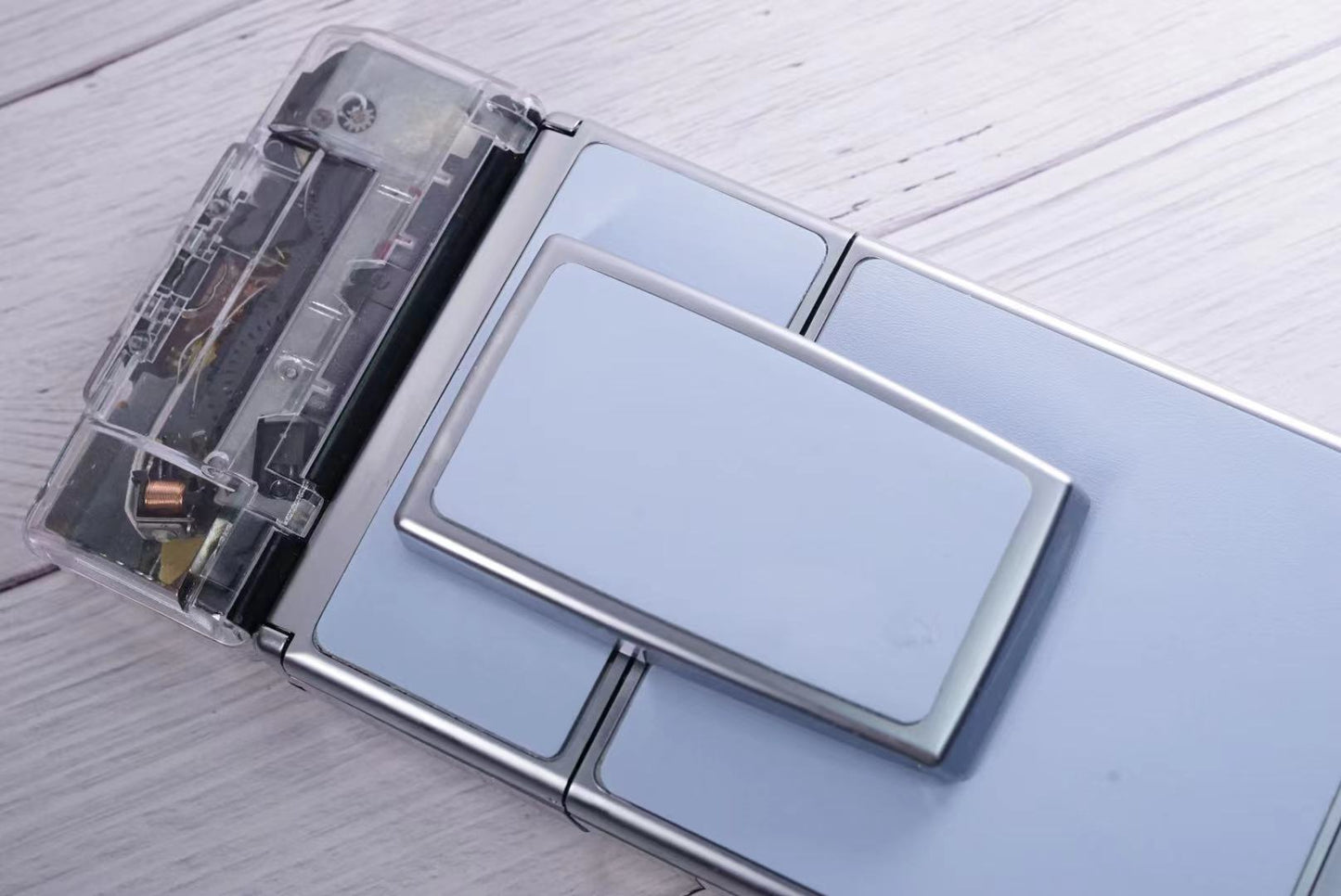 Polaroid SX70 SONAR Transparent vision ISO600 BABY BLUE Shutter button